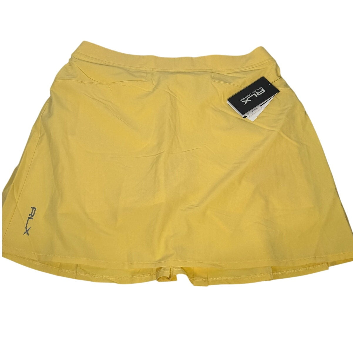 Ralph Lauren RLX women's yellow pleated golf skort, size M, new with tags, showing the front view of the stylish athletic skirt.