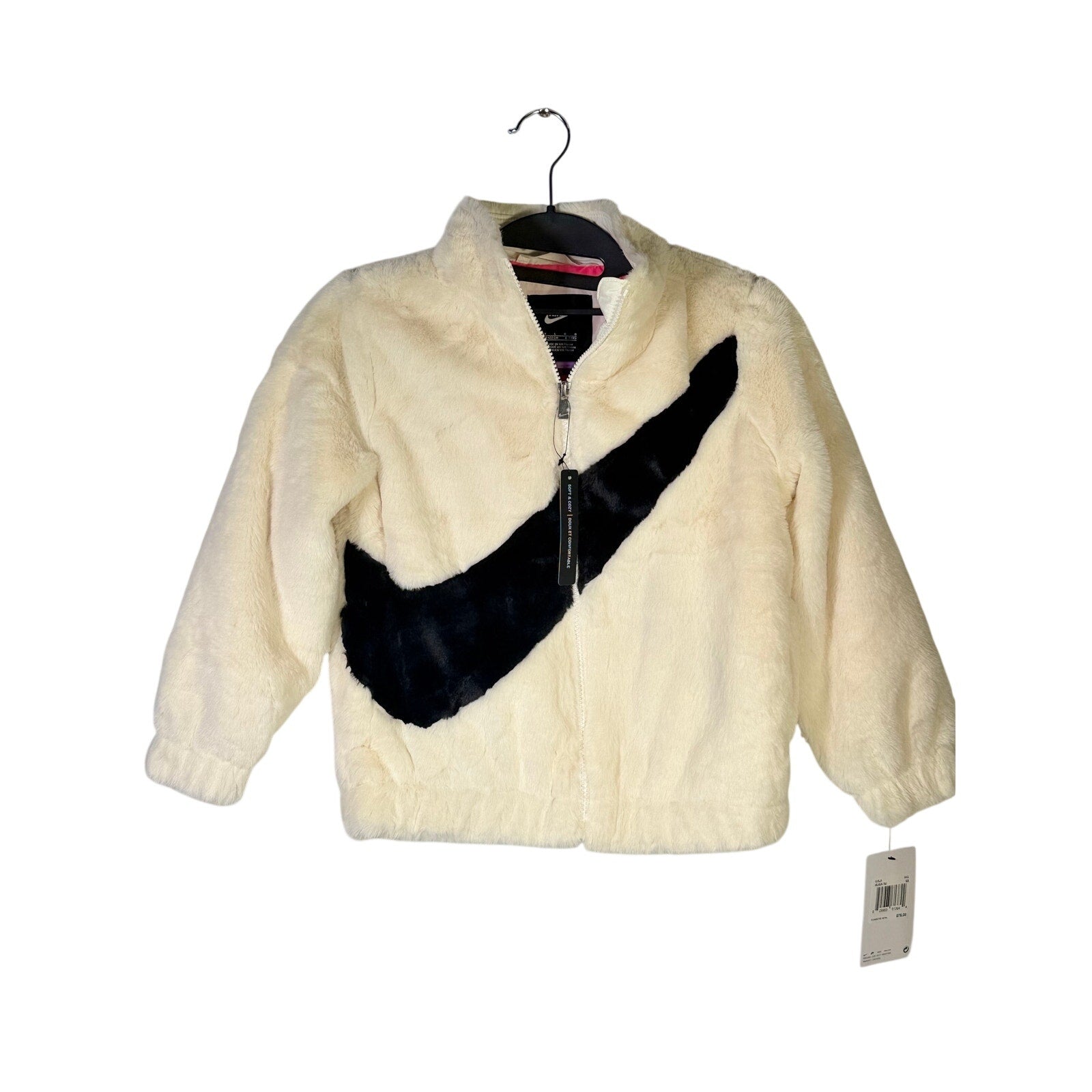 Nike girls' faux fur zip jacket in cream and black, oversized fit with Nike swoosh logo, size 6X, new with tags.
