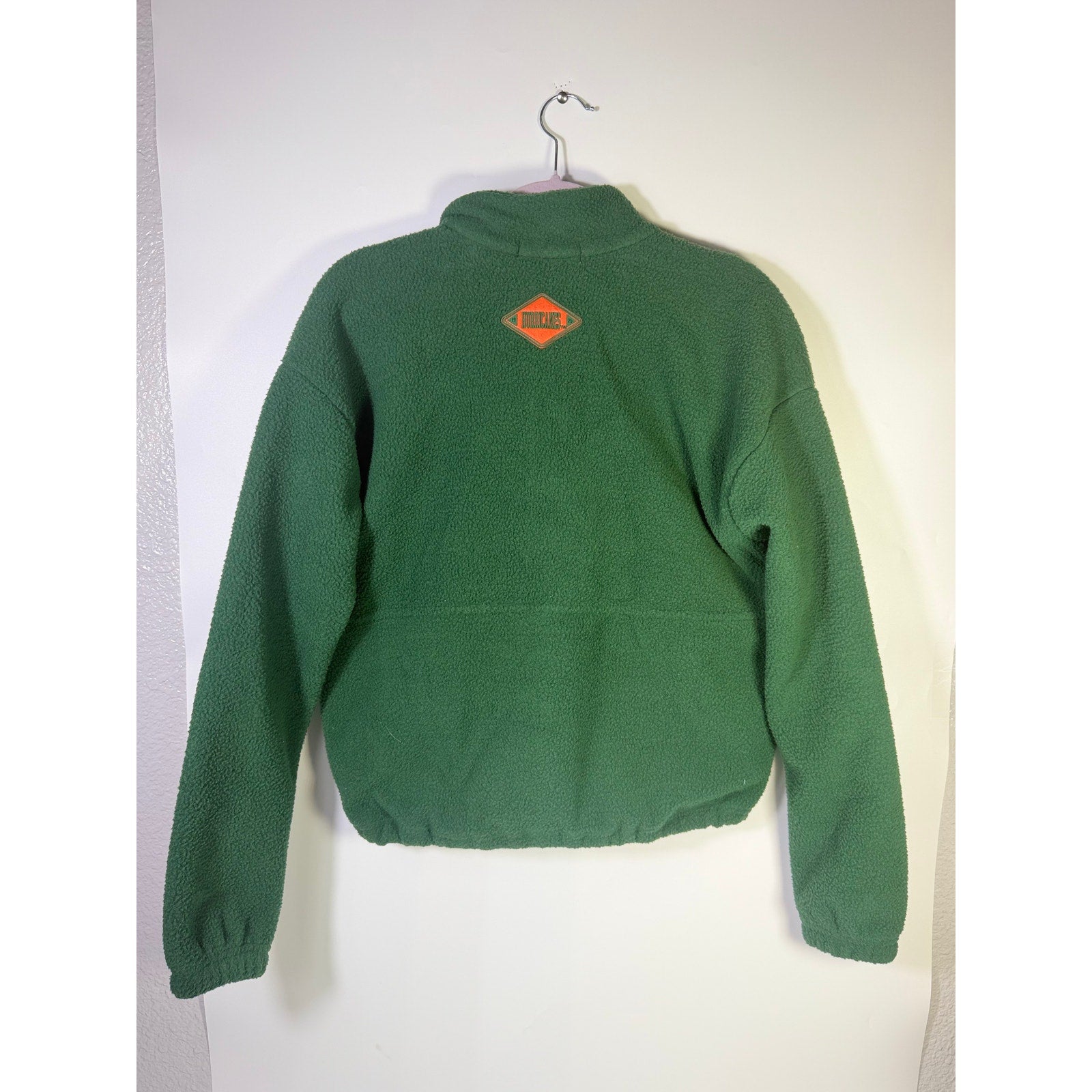 Wear by Erin Andrews women's Miami Hurricanes green quarter-zip fleece sweatshirt, size small, shown on a model.