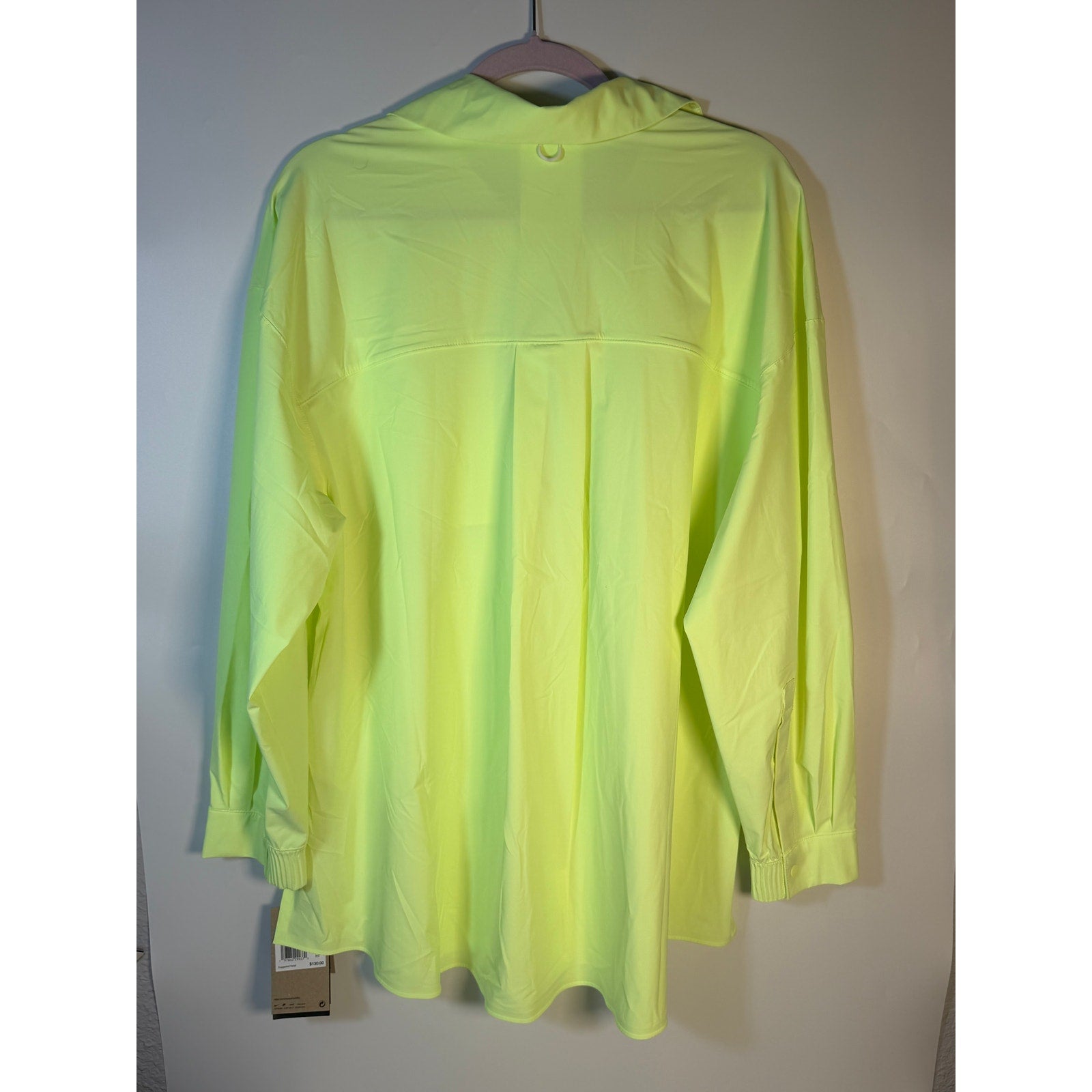 Nike 24.7 Dri-FIT women's long sleeve training shirt in neon yellow, shown laid flat on a white background.