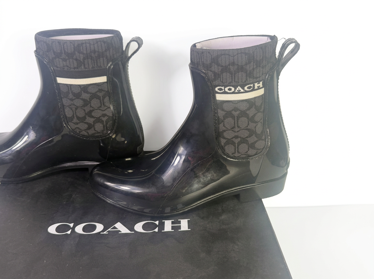 Coach women's black Signature Jacquard Knit Chelsea rain bootie size 7B with box, showcasing stylish waterproof footwear.
