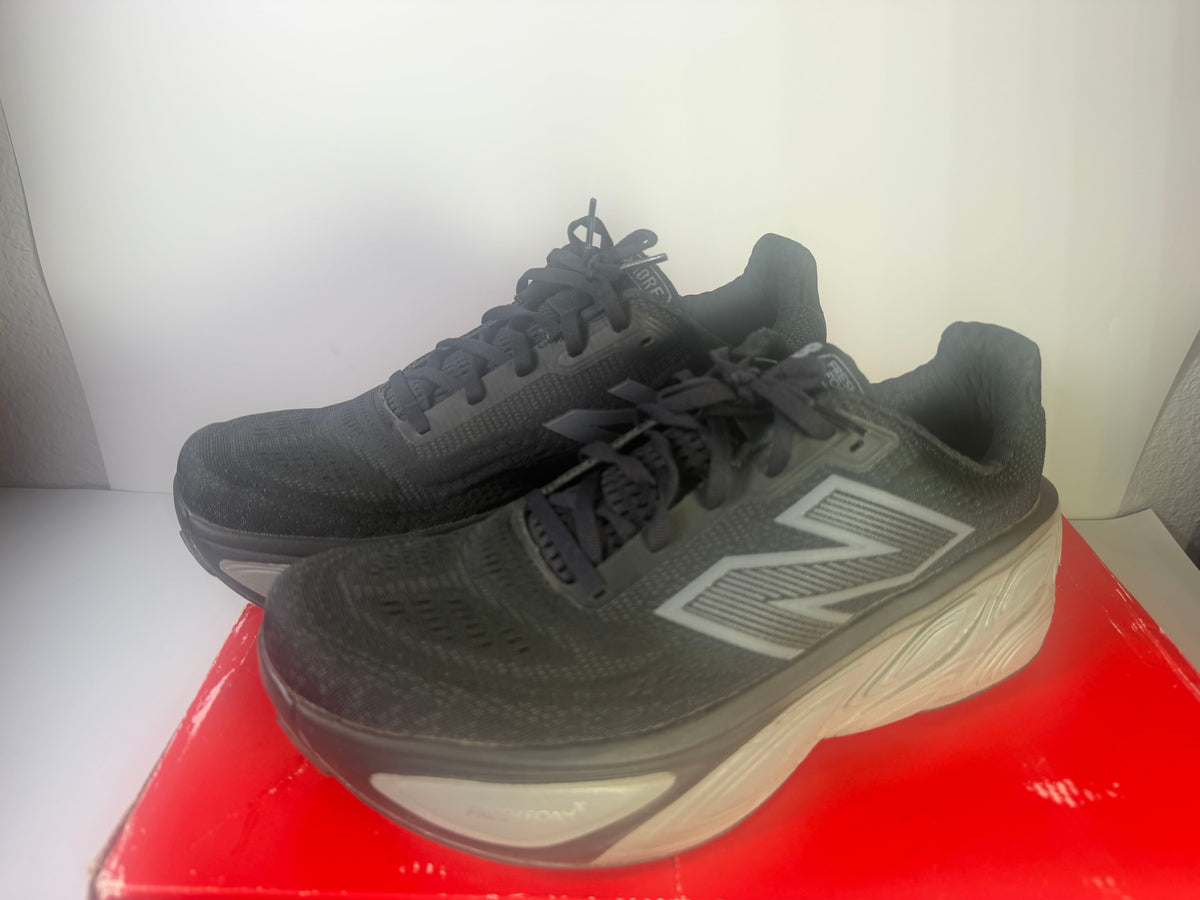 Black New Balance Fresh Foam X More v5 men's athletic running shoes, size 11, with sleek design and supportive cushioning.