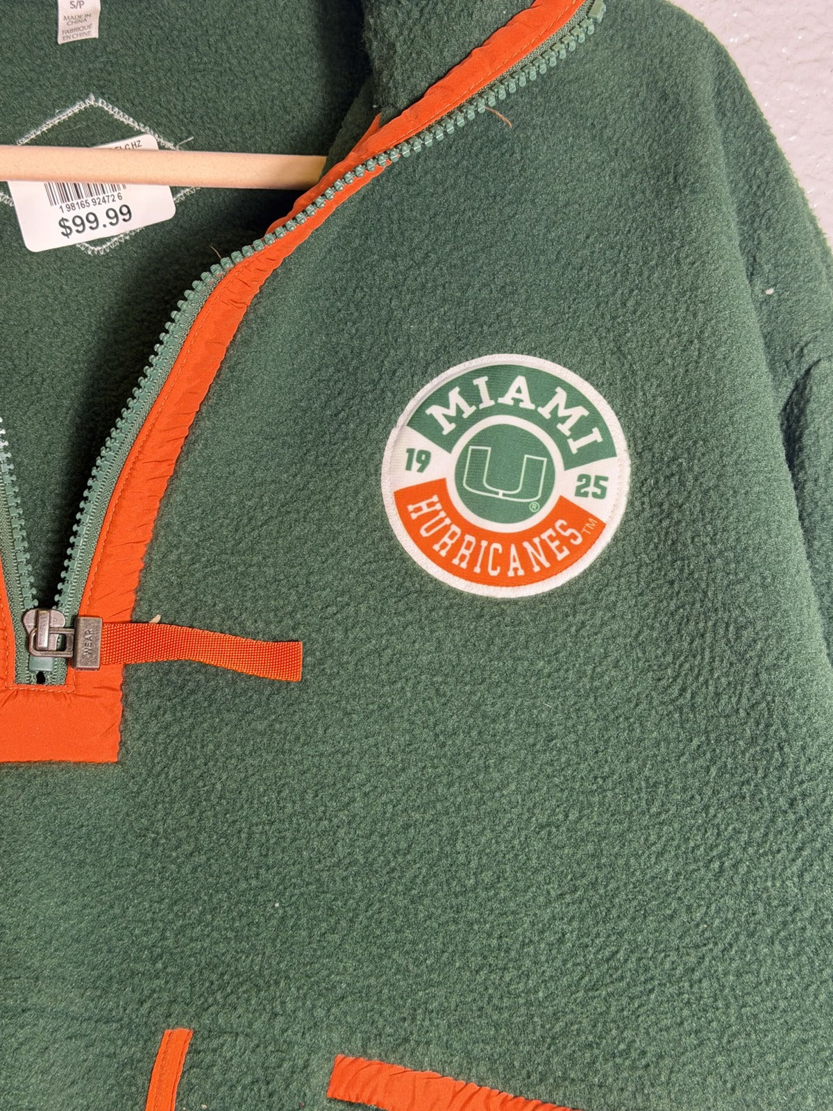 Green and orange Miami Hurricanes fleece pullover by WEAR by Erin Andrews, women's 1/4 zip sweatshirt, size small, front view