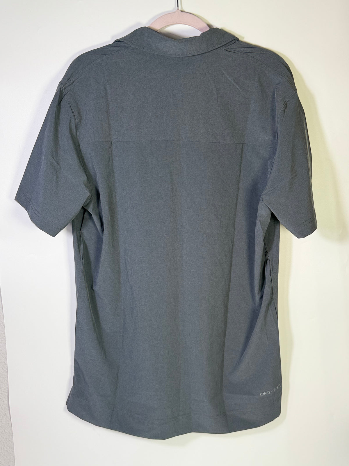 Men's Nike Dri-FIT gray football sideline polo shirt, large size, lightweight athletic clothing, close-up of fabric and collar.