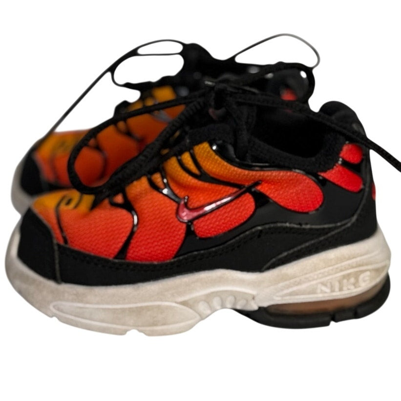 Pre-owned Nike Air Max athletic sneakers in orange, red, and black with lace-up design, size 5C, shown from a front angle.