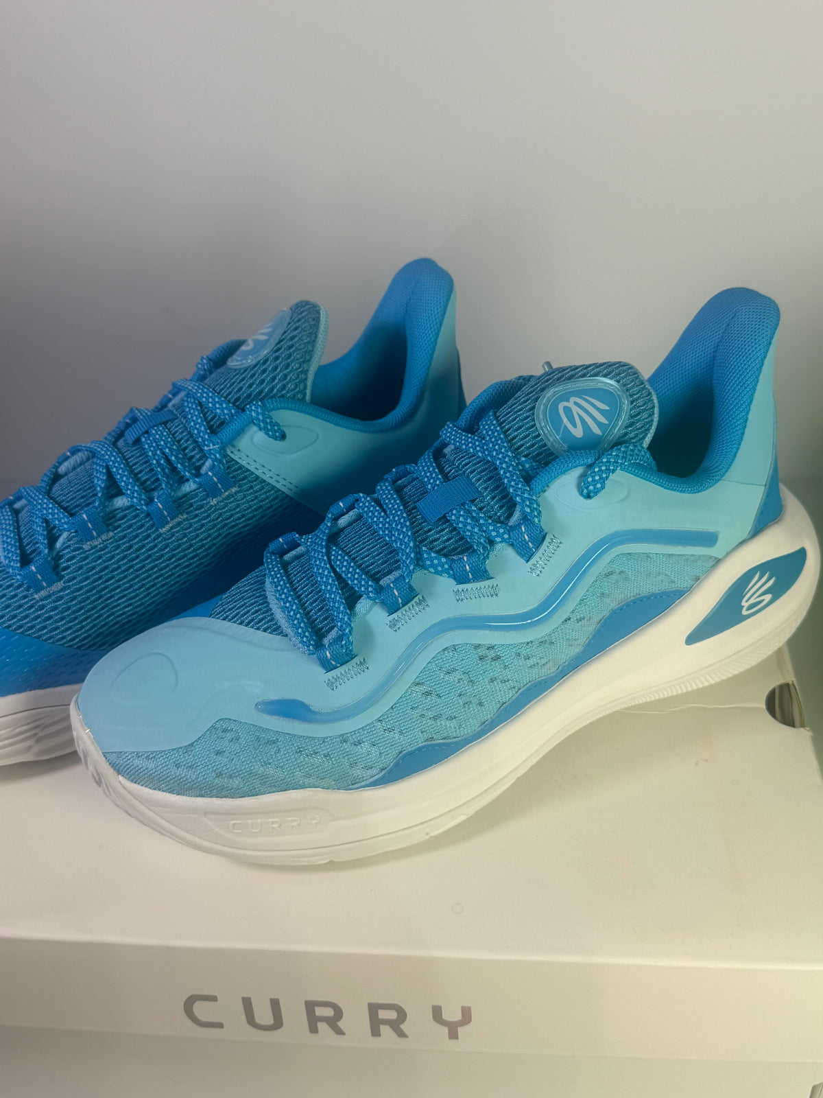 Under Armour Curry Flow basketball shoes in blue for youth, size 7Y, featuring a sporty design and supportive sole.