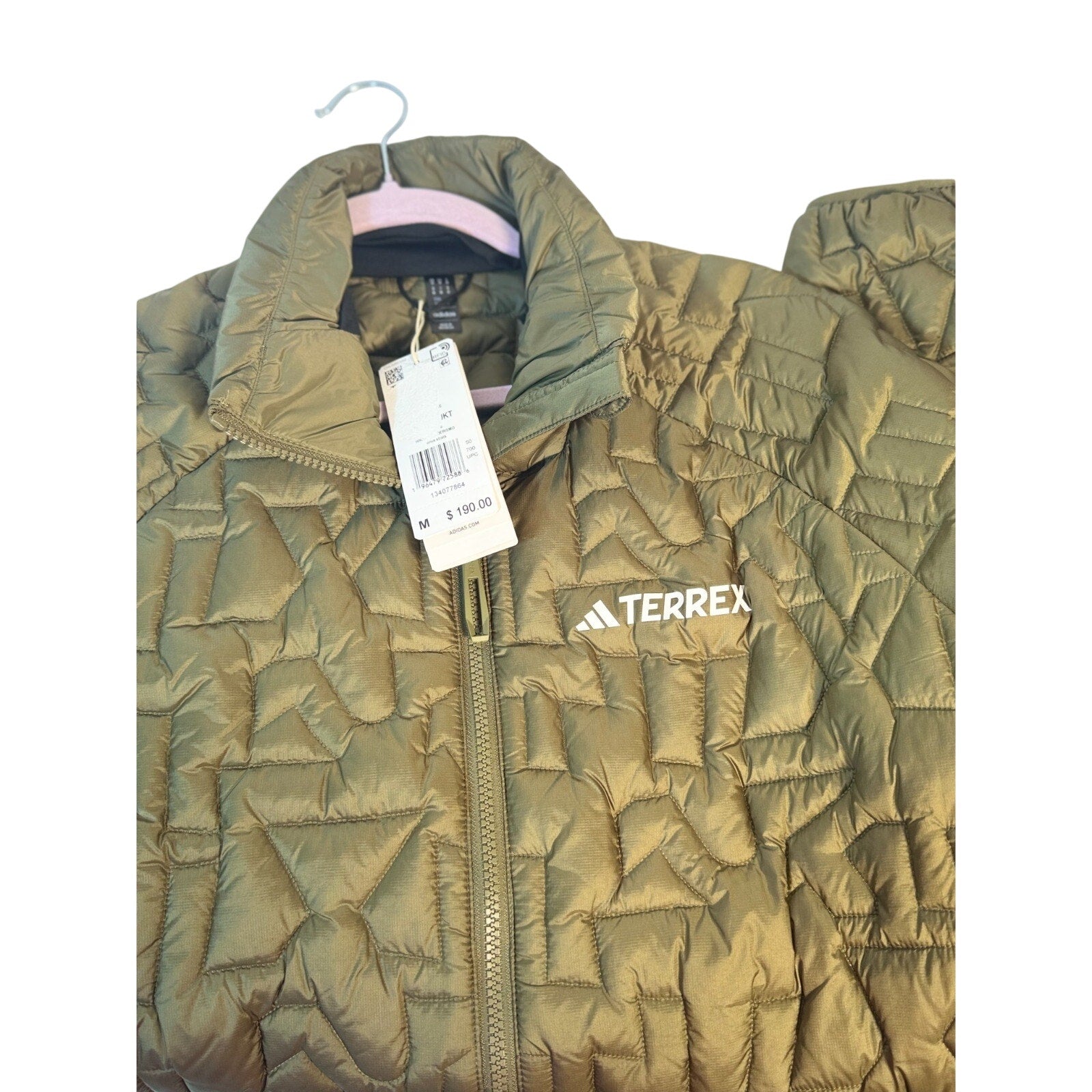 Men's Adidas Terrex insulated puffer jacket in olive green, medium size, new with tags, featuring a quilted design and high collar.