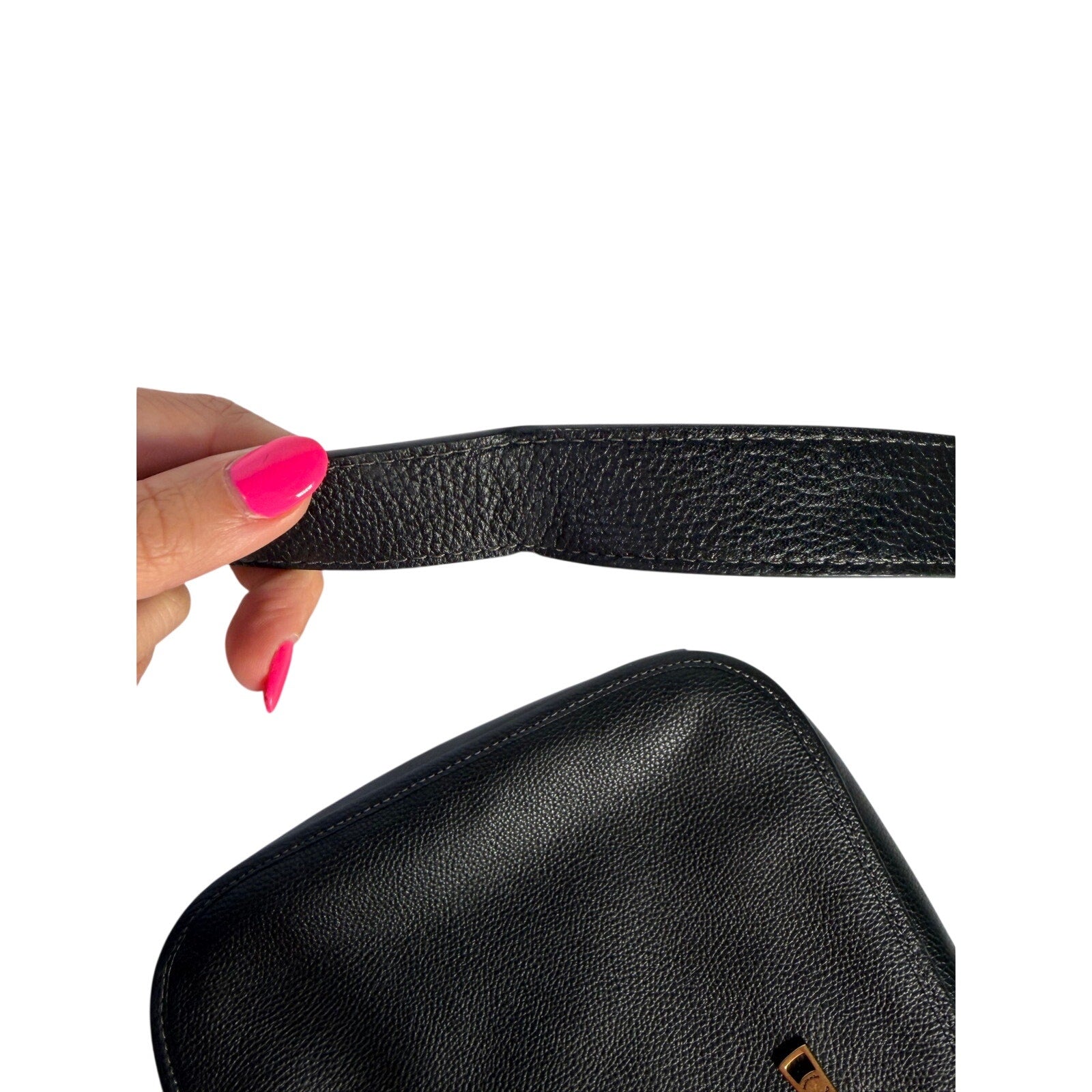Coach women's black pebbled leather crossbody handbag with gold-tone hardware, featuring a sleek shoulder strap and elegant design.
