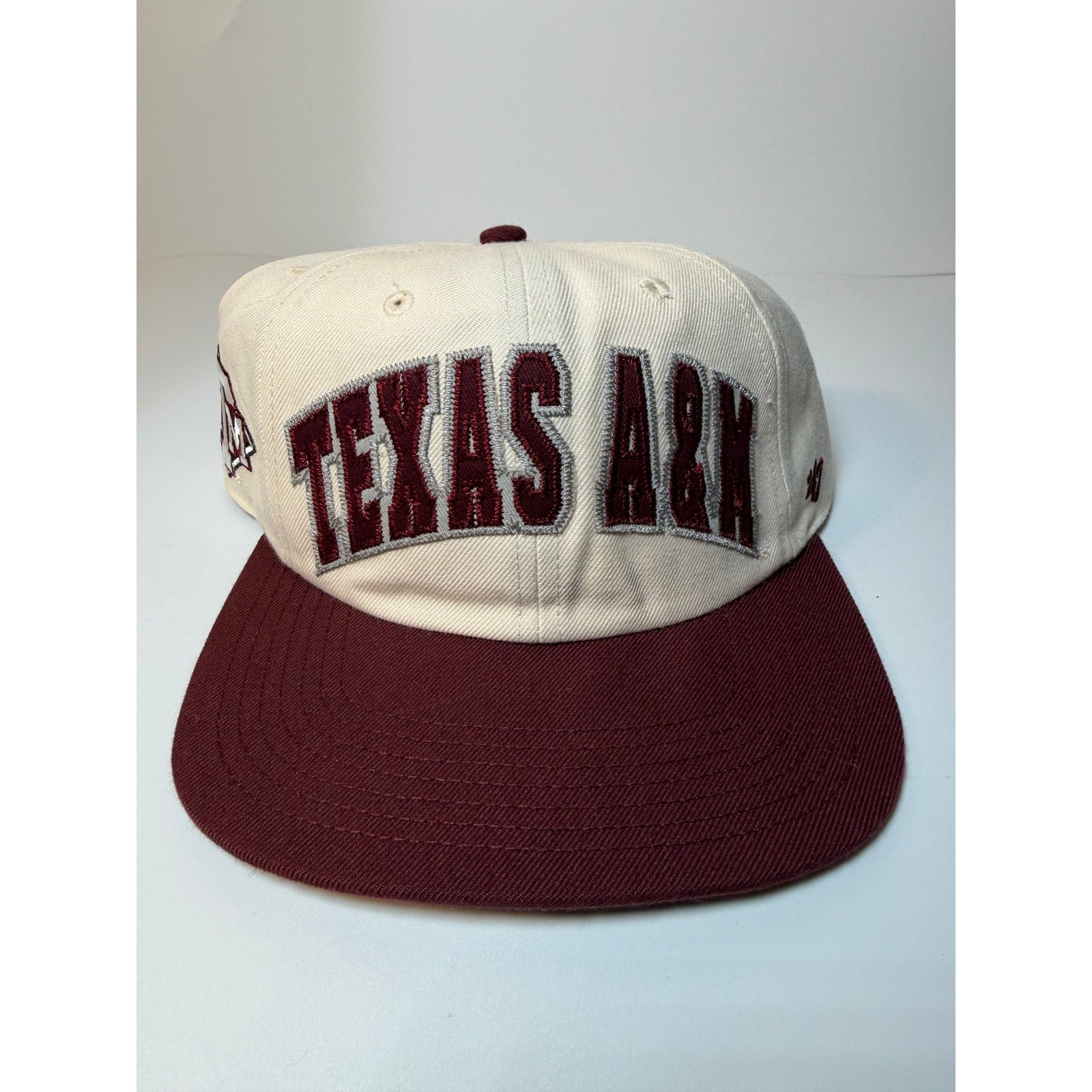 47 Brand Texas A&M Aggies snapback hat in cream and maroon with adjustable strap, featuring team logo on front.