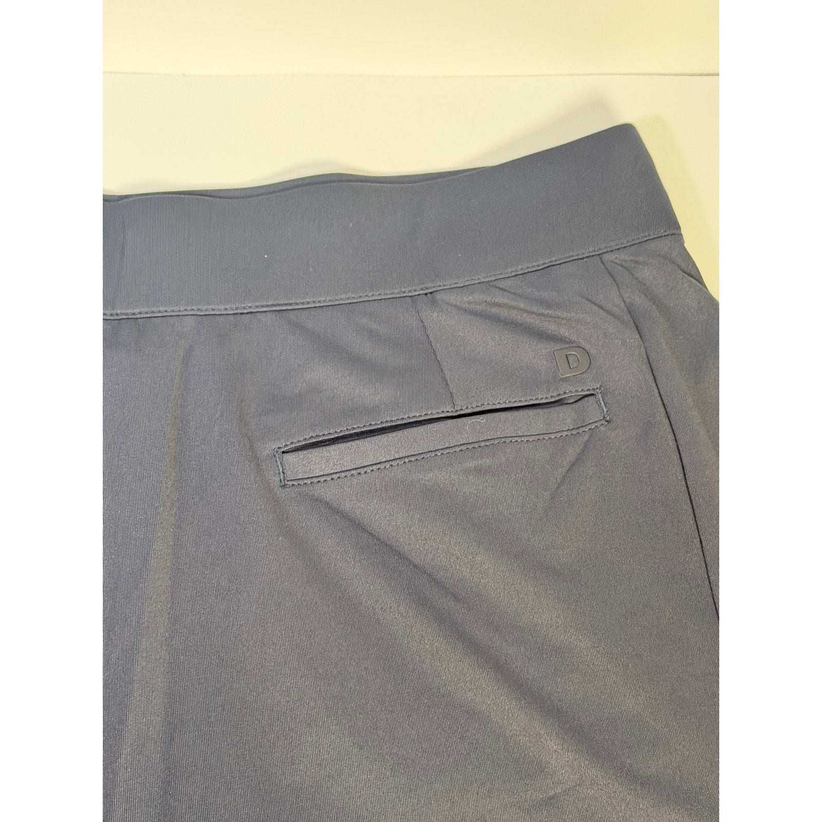Dunning women's navy golf skort with built-in shorts, athletic style, size large, featuring a pleated skirt design.