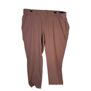 Under Armour UA Drive Tapered Golf Pants for men, maroon mist color, size 42x30, showing the tapered fit and fabric details.