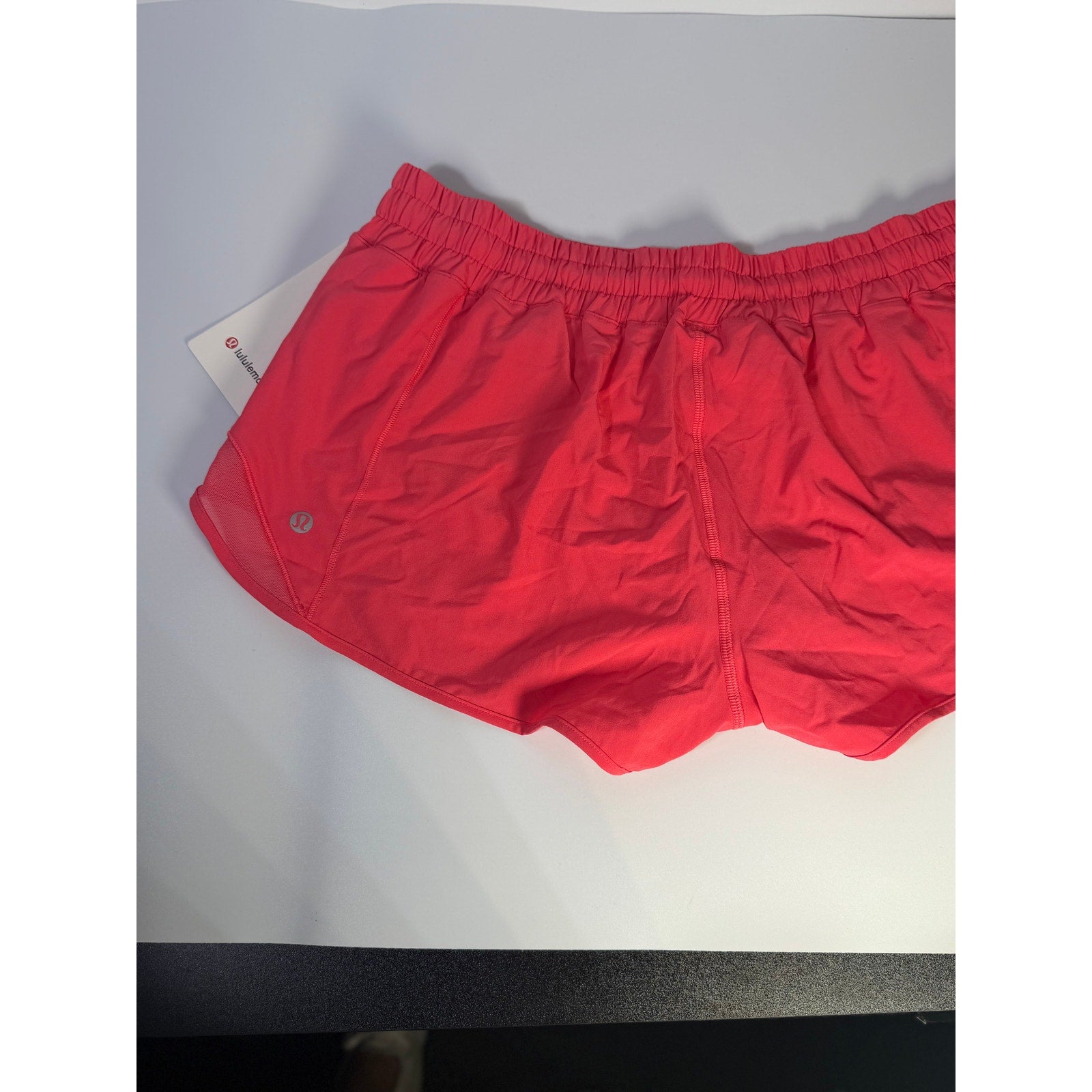 Lululemon Hotty Hot lined shorts in glaze pink, low rise, 2.5-inch length, women's size 14, with visible lining and athletic fit.