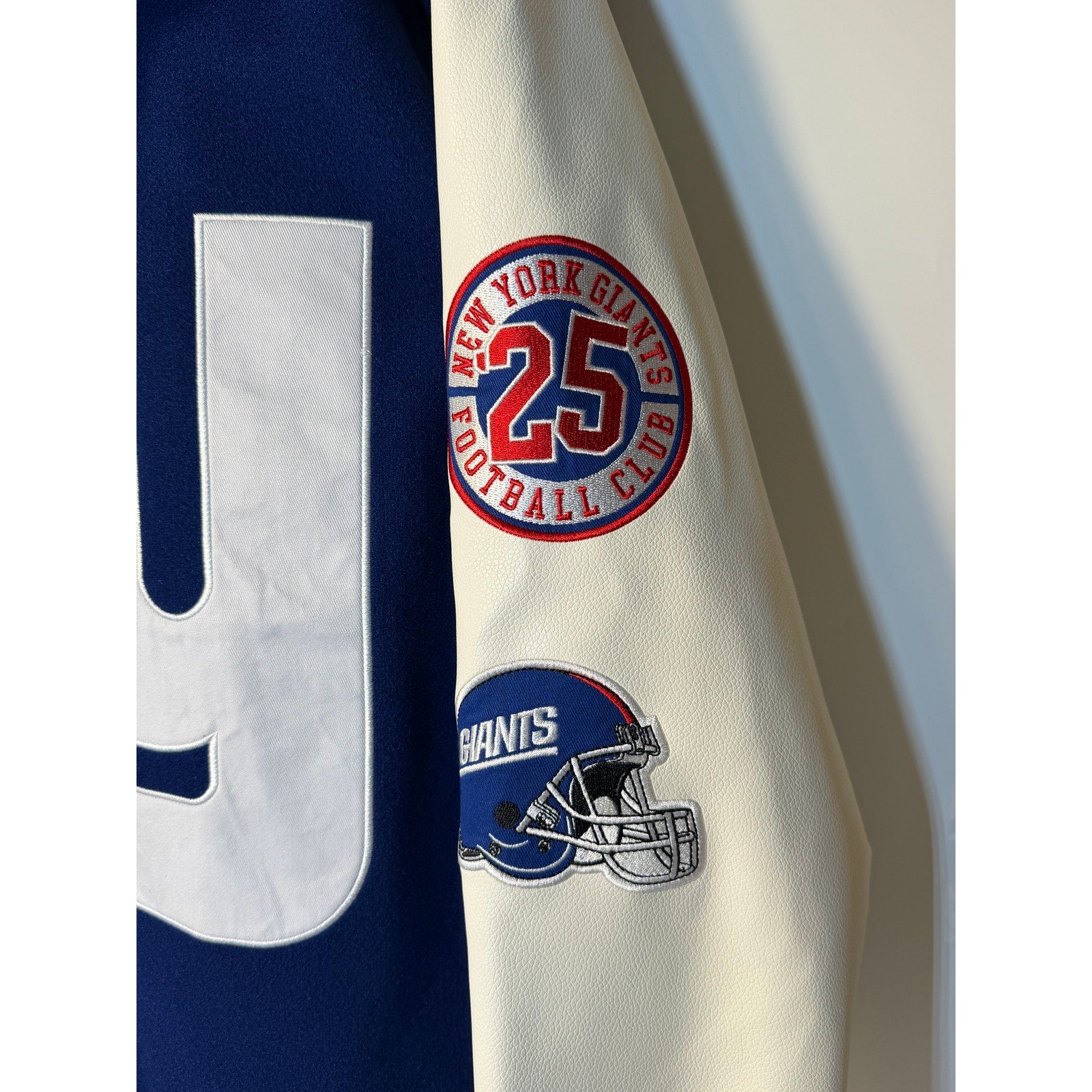 New York Giants women's varsity hooded jacket in blue and white, casual NFL jacket by The Wild Collective.