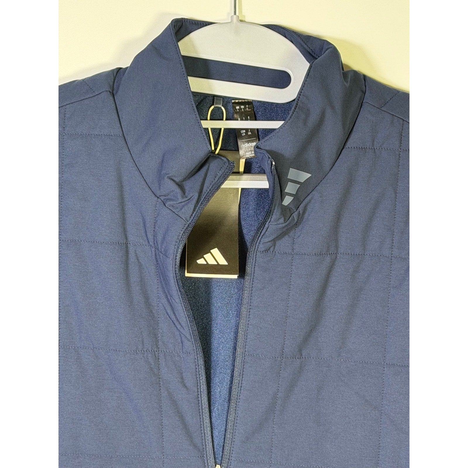 Adidas Ultimate365 Quilted DWR men's navy blue golf jacket, size L, showing front view with quilted design and water-resistant fabric.