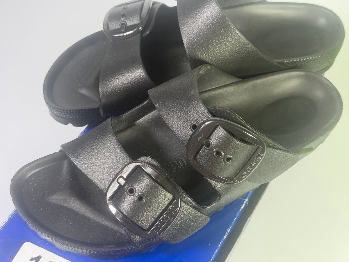Black Birkenstock Arizona EVA sandals with large buckle, narrow fit, worn by a woman in US size 7, EU 38.