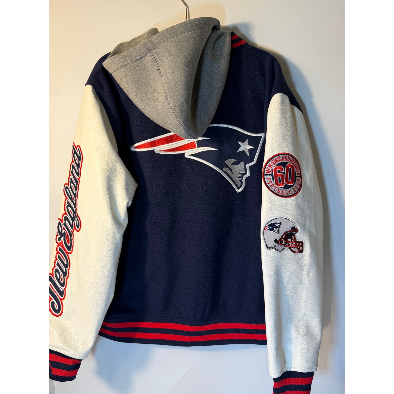 New England Patriots women's varsity hoodie in blue and white with embroidered team logo, faux leather accents, and a cozy wool blend.