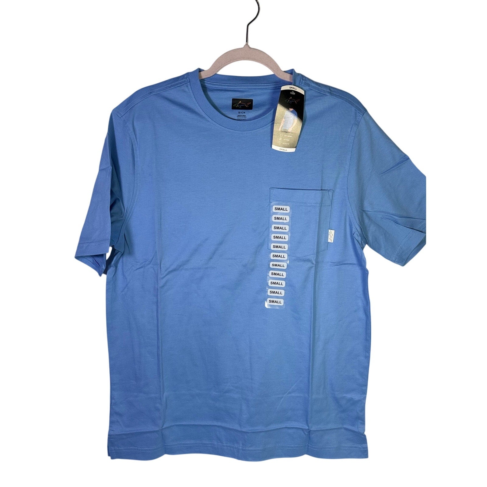 Greg Norman men's blue relaxed fit pocket T-shirt, size small, laid flat with visible pocket and soft cotton fabric.