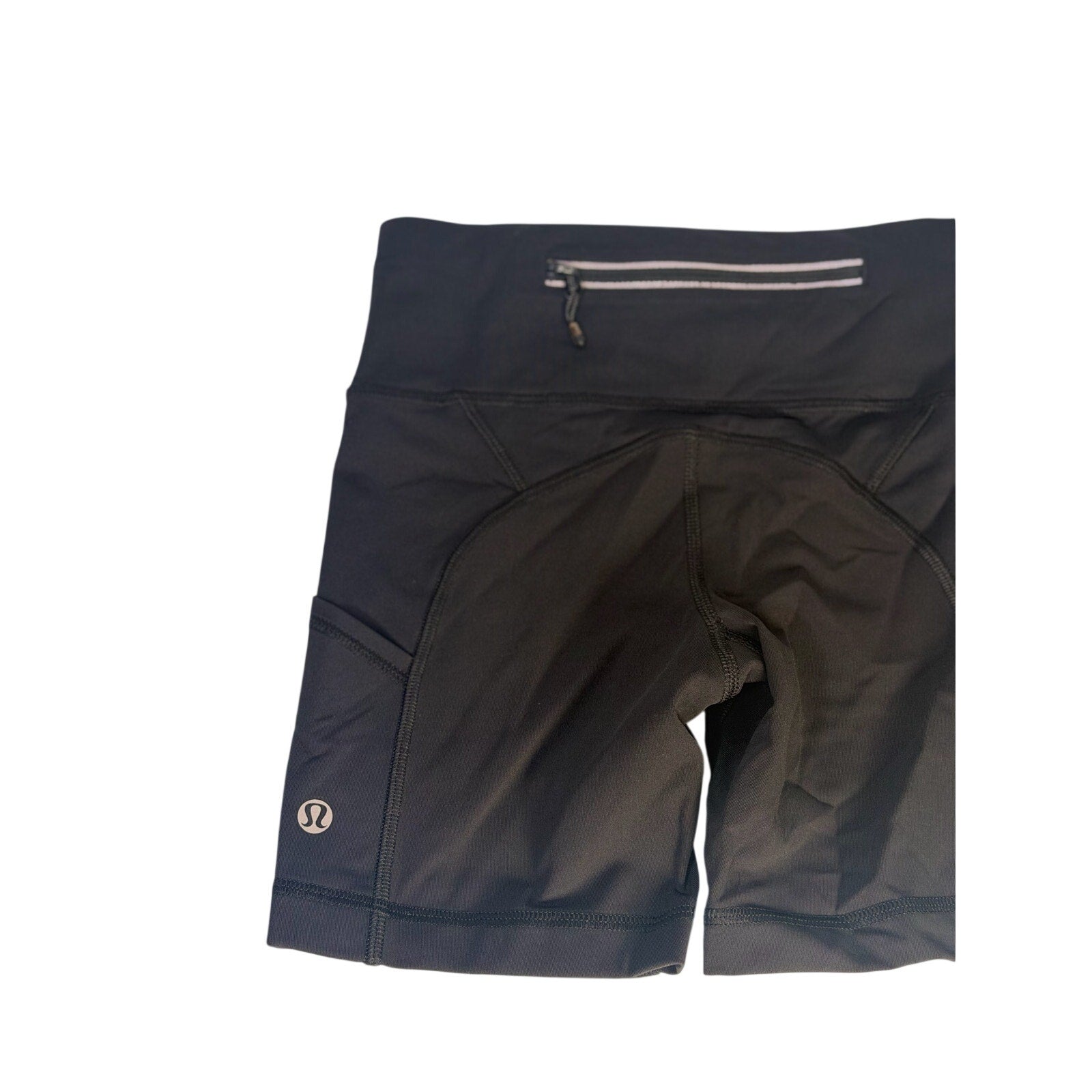 Lululemon women's black high-rise biker shorts with pockets, size 2, shown on a model, close-up of fabric and waistband.