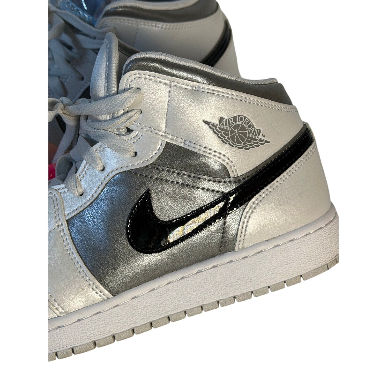 White, gray, and black Air Jordan 1 Mid GS sneakers for youth, size 7Y, featuring classic Jordan sneaker design.