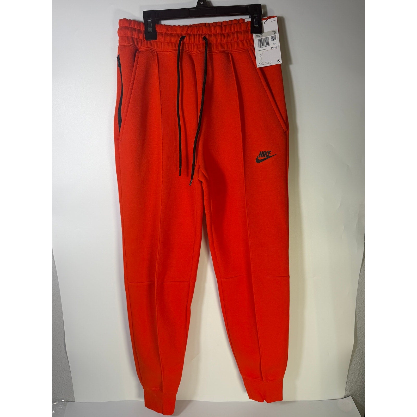 Nike Sportswear Phoenix Fleece Jogger Pants for women in bright orange, mid-rise, XS size, showing relaxed fit and fleece material.