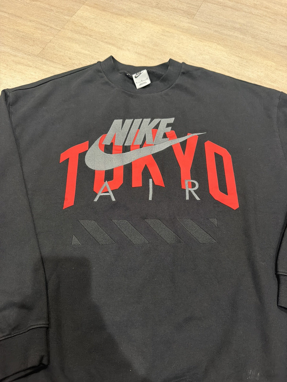 Nike Air Tokyo Crewneck Sweatshirt in black with red and gray embroidered swoosh, unisex size M, casual clothing for men and women.