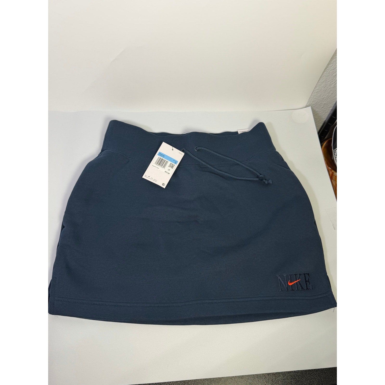 Nike women's navy blue fleece drawstring mini skirt, size M, with elastic waistband and casual sporty style.