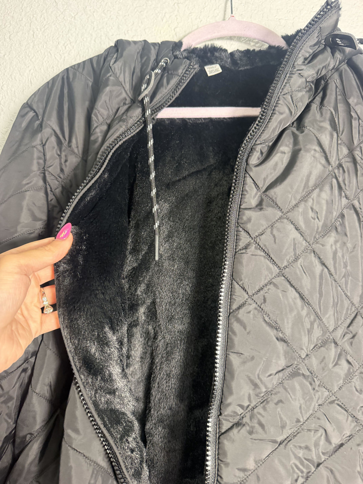 Women's Free Country Cloud Lite reversible quilted faux fur hooded jacket in black, showing the lightweight, cozy design and hood details.