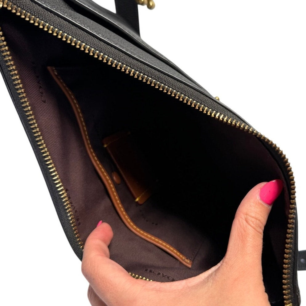 Coach women's black pebbled leather crossbody handbag with gold-tone hardware, featuring a sleek shoulder strap and classic design.