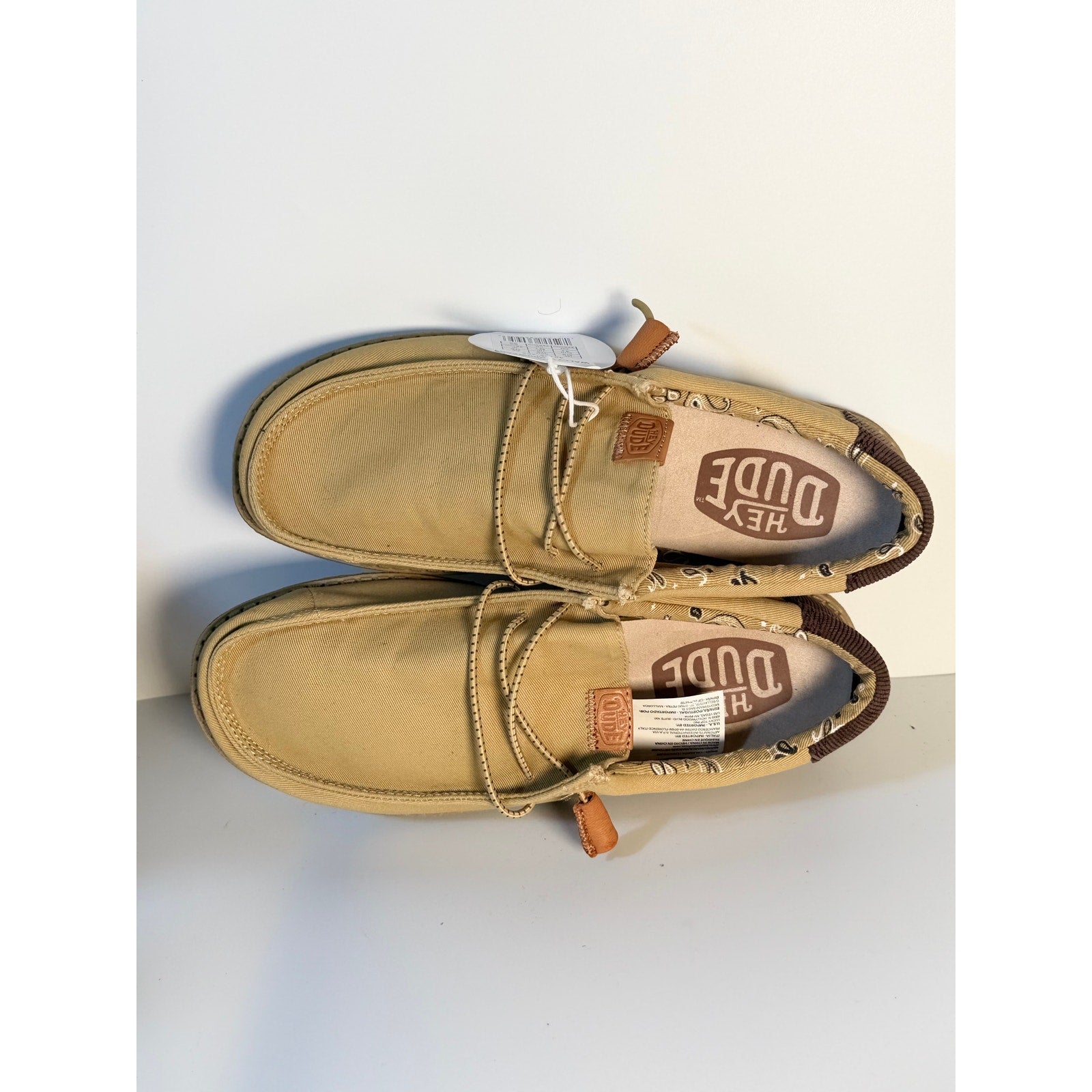 Hey Dude Wally Workwear loafers in tan, lightweight men's size 8 and women's size 10, showing the casual slip-on style.