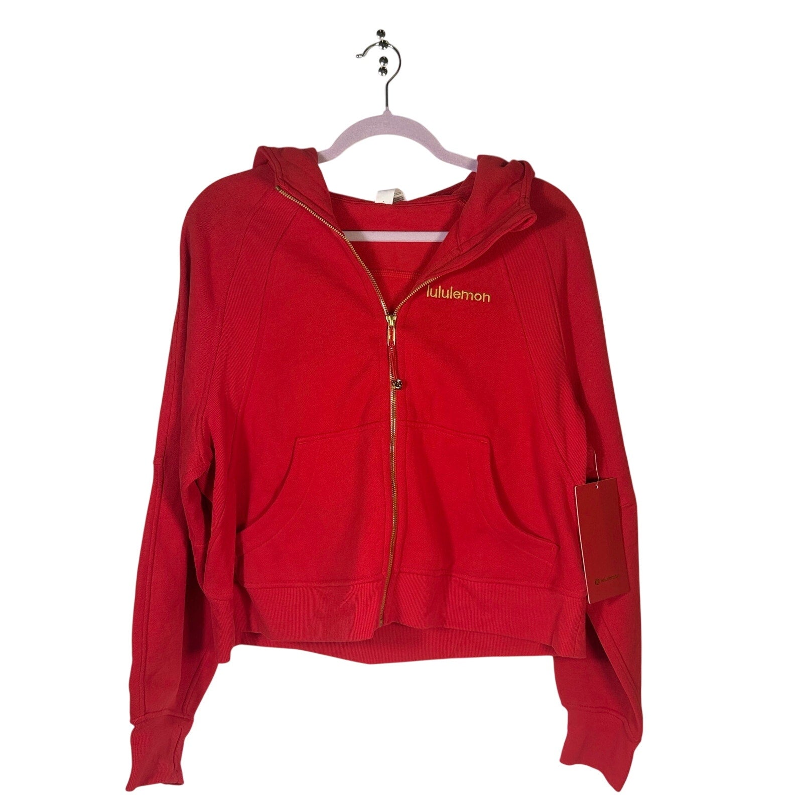 Lululemon women's red scuba oversized full-zip hoodie with gold accents, size M/L, displayed flat with hood and zipper visible.