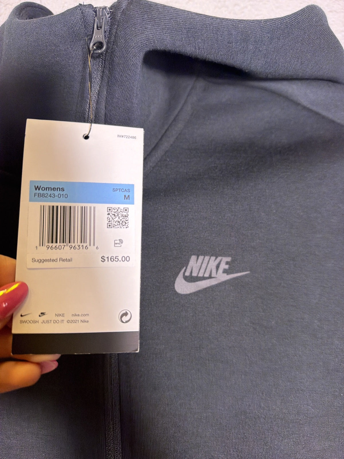 Nike Sportswear Tech Fleece women's oversized black full-zip hoodie, size M, front view, soft fleece material, brand logo visible.