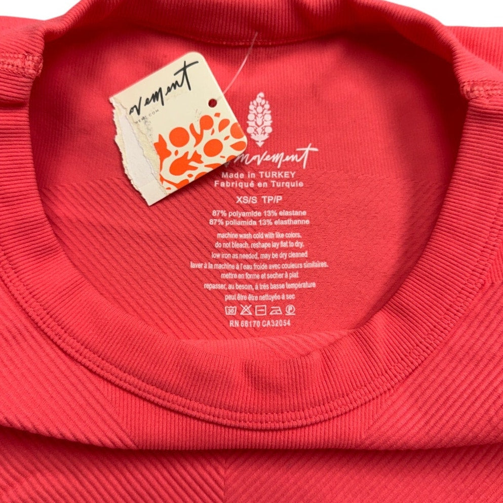 FP Movement coral pink ribbed cropped tank top, XS/S, stylish performance workout top with a fitted design.