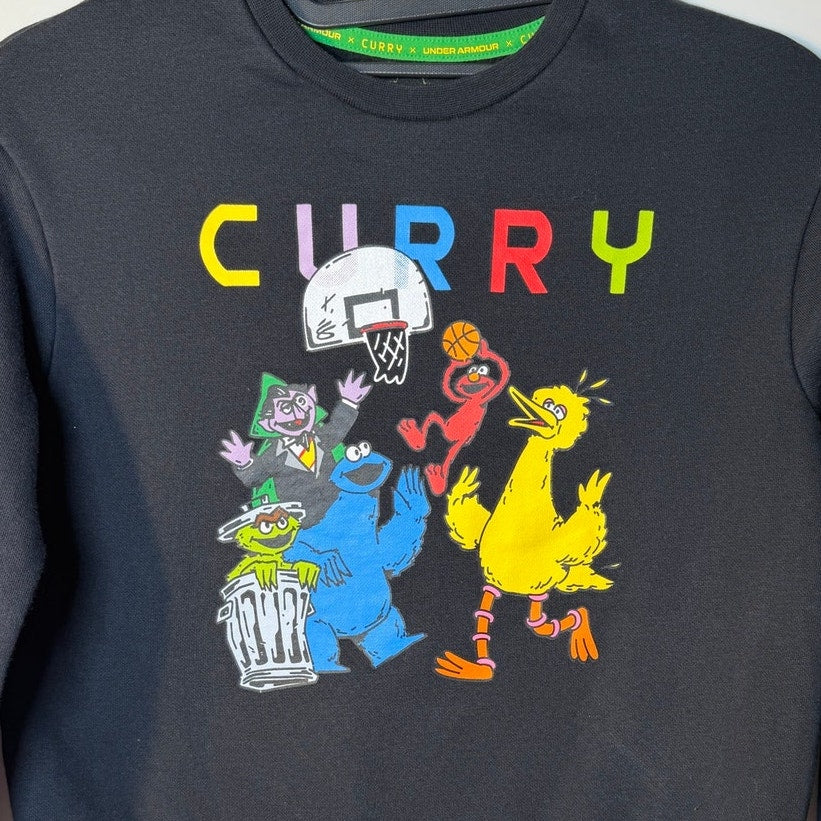 Black Under Armour Curry x Sesame Street youth crewneck sweatshirt with colorful Sesame Street character graphics in a casual fit.