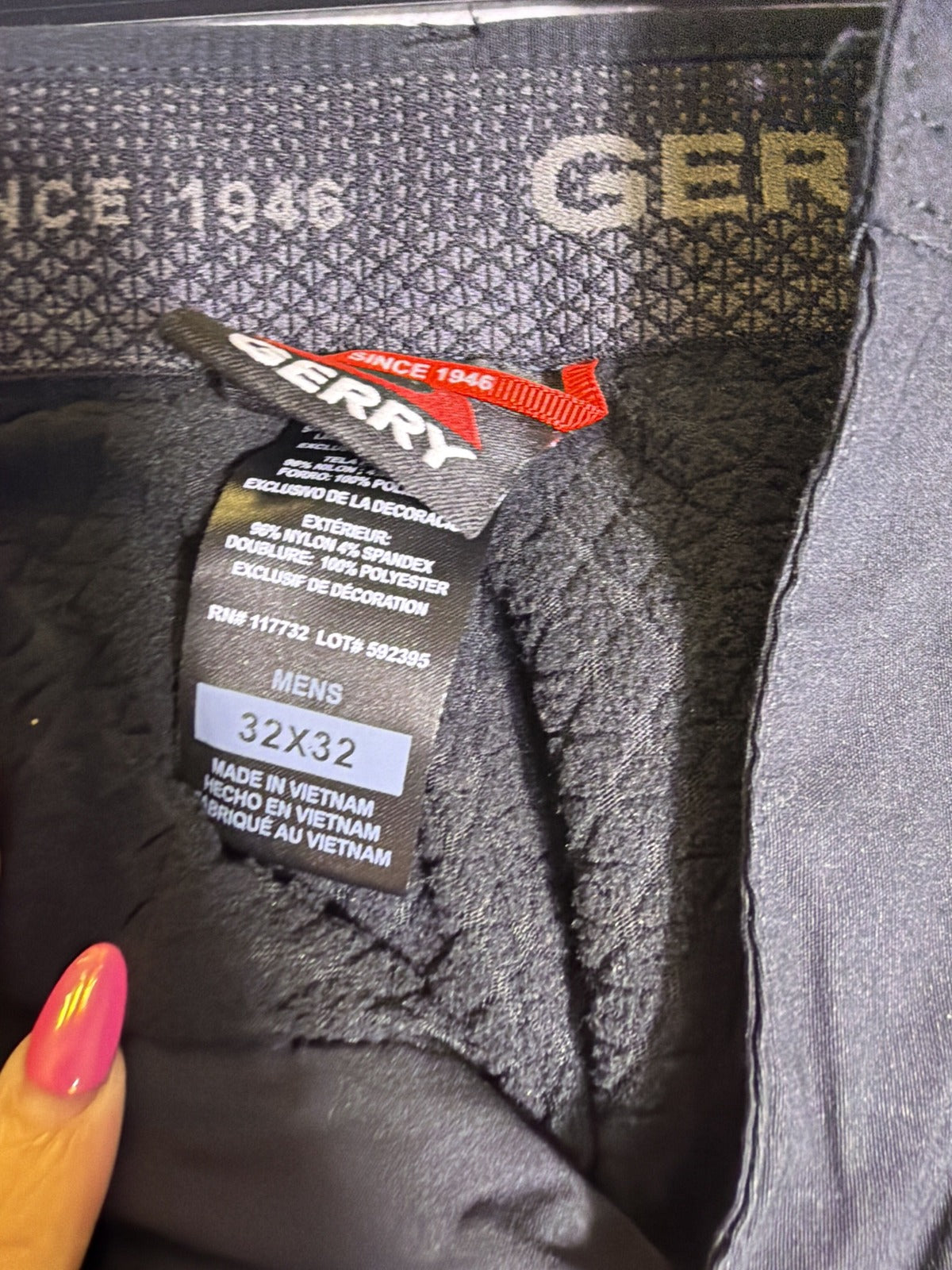 Black Gerry men's fleece-lined stretch pants in size 32x32, shown laid flat with visible waistband and fabric texture.