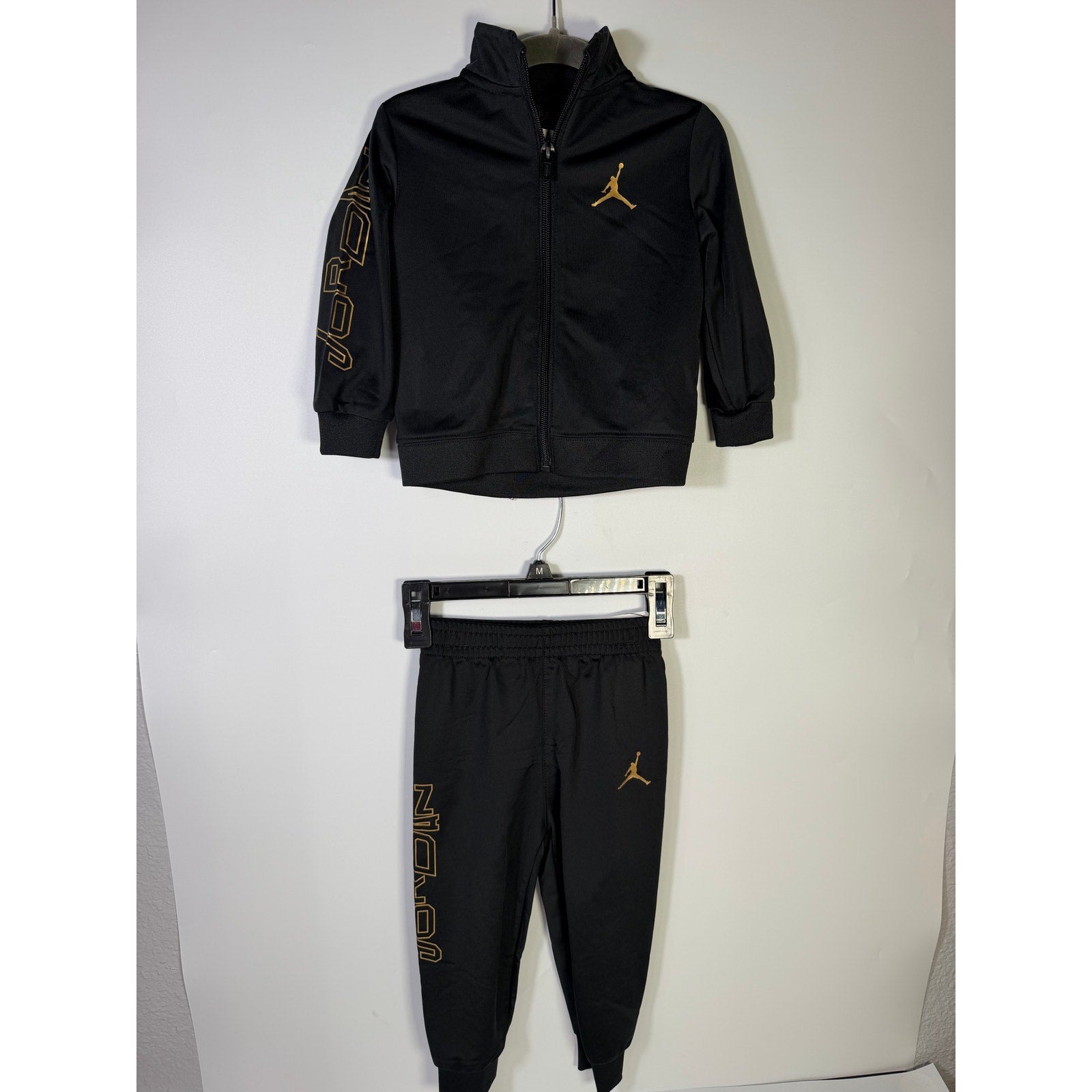 Jordan baby boys 2-piece black and gold track jacket and jogger set, size 18 months, new with tags, casual athletic clothing.