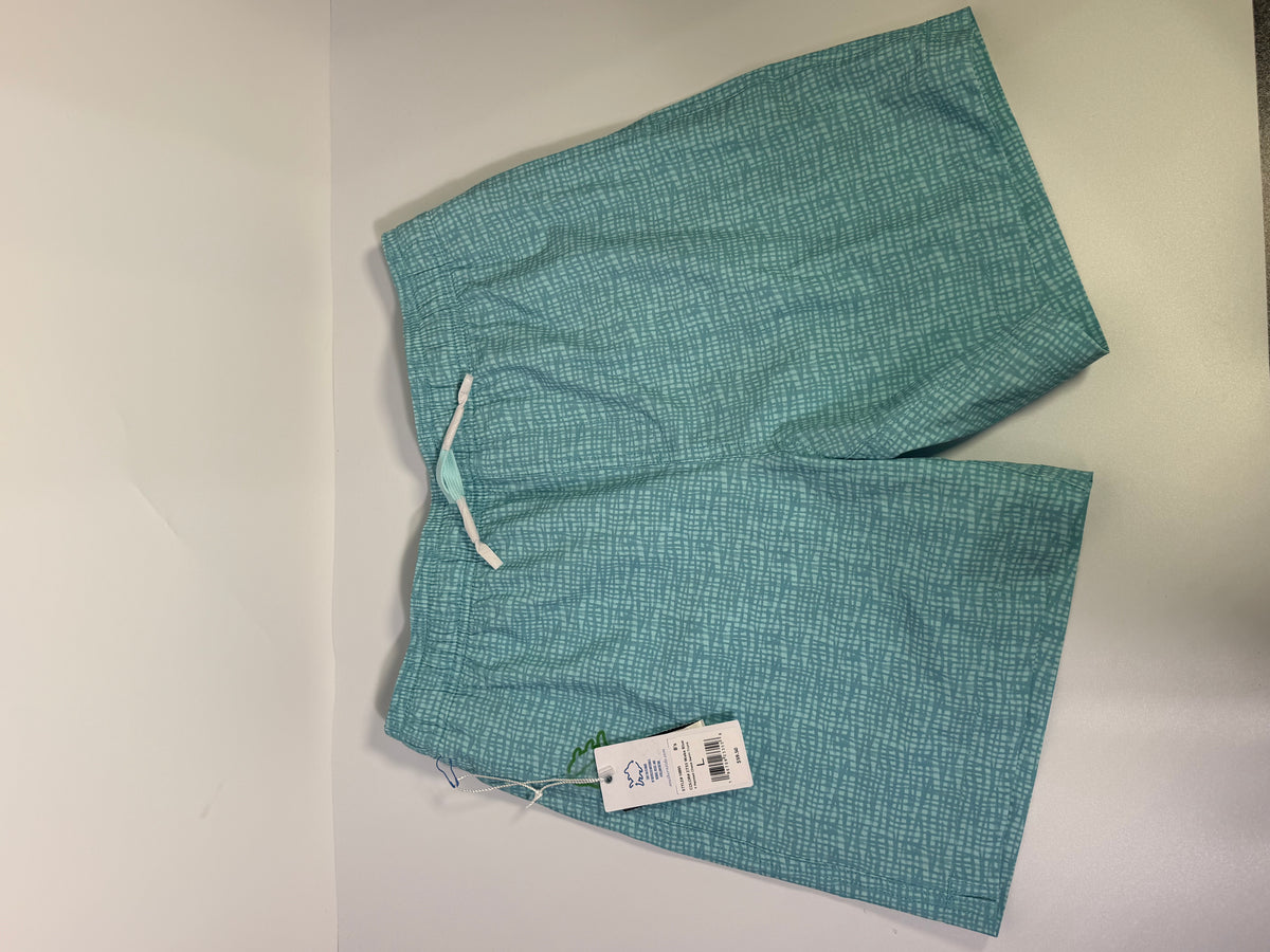 Southern Tide teal printed performance swim trunks displayed on a model, showcasing their vibrant design and comfortable fit.