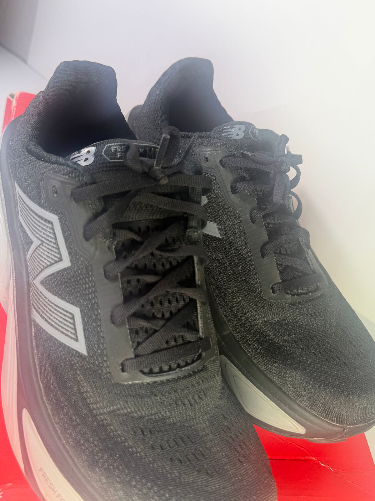 Black New Balance Fresh Foam X More v5 men's athletic running shoes in size 11 with cushioned design and breathable mesh upper.