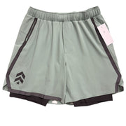 Men's green and black Lululemon Pace Breaker lined shorts with a relaxed fit, displayed on a hanger.