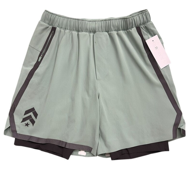 Men's green and black Lululemon Pace Breaker lined shorts with a relaxed fit, displayed on a hanger.