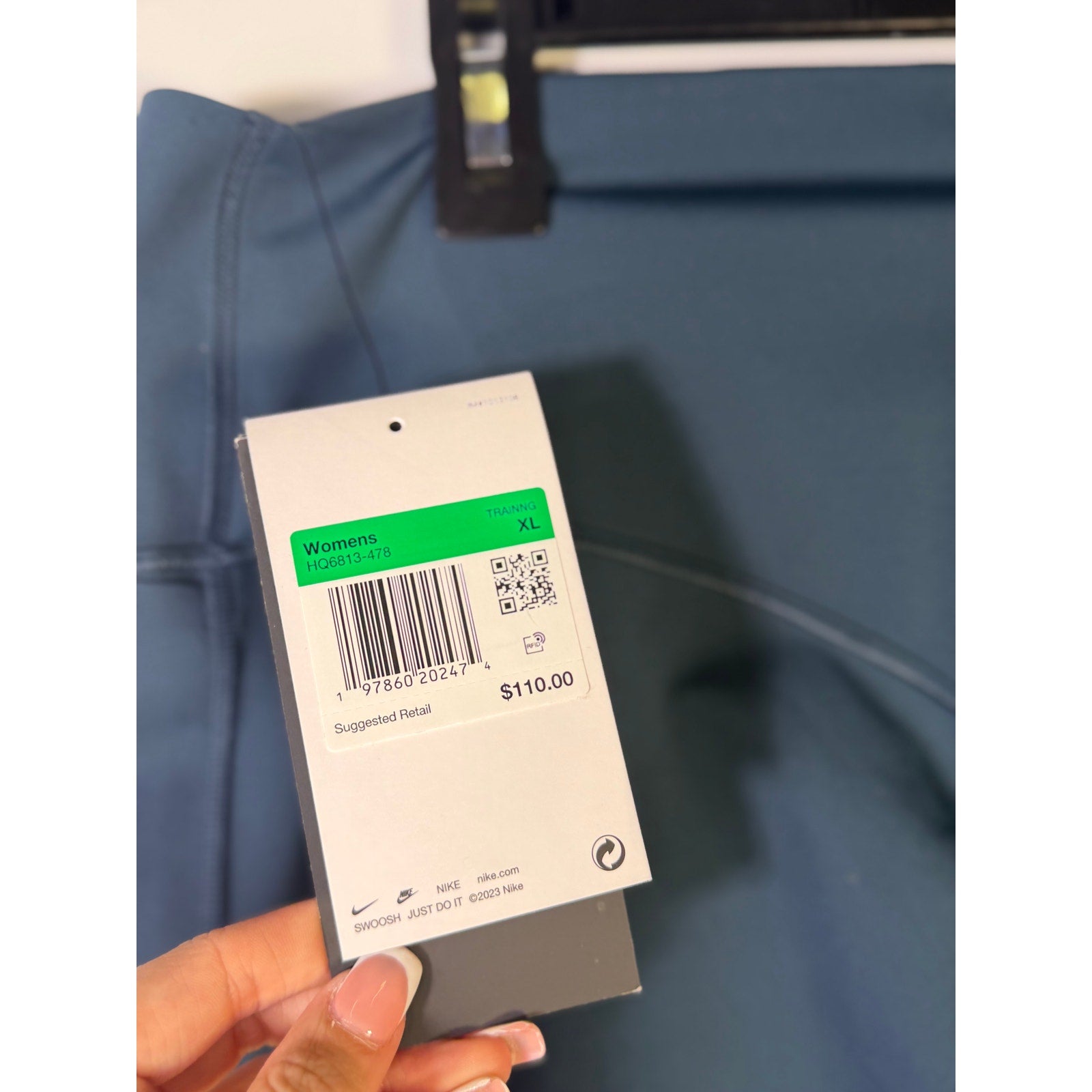 Nike Women's blue high-waisted training leggings in XL, shown laid flat, with a smooth stretch fabric and subtle Nike logo.