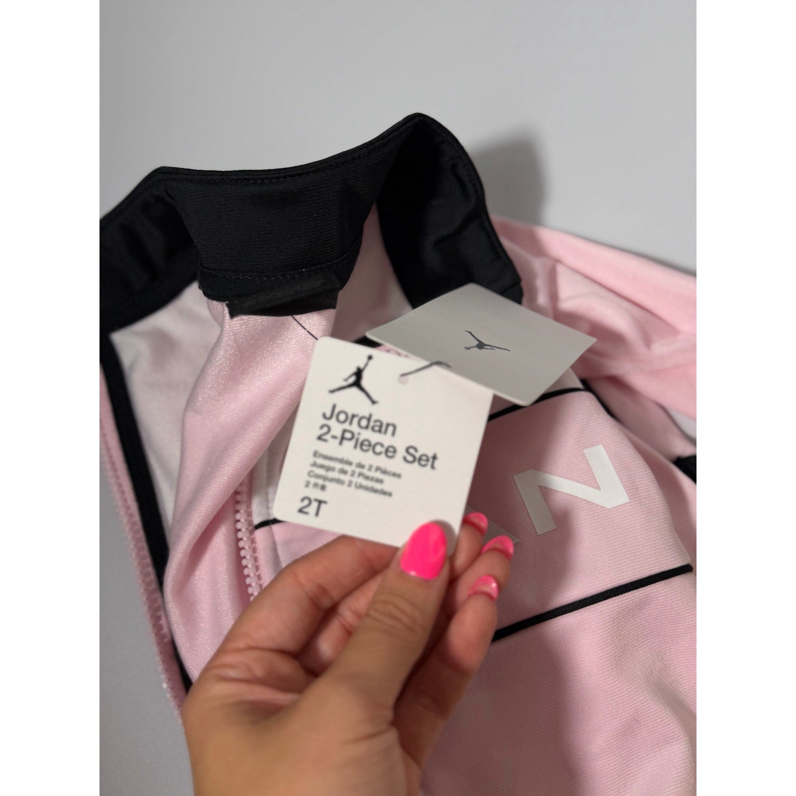 Jordan toddler girls pink and black 2-piece track jacket and pants set, size 2T, new with tags, casual athletic clothing.