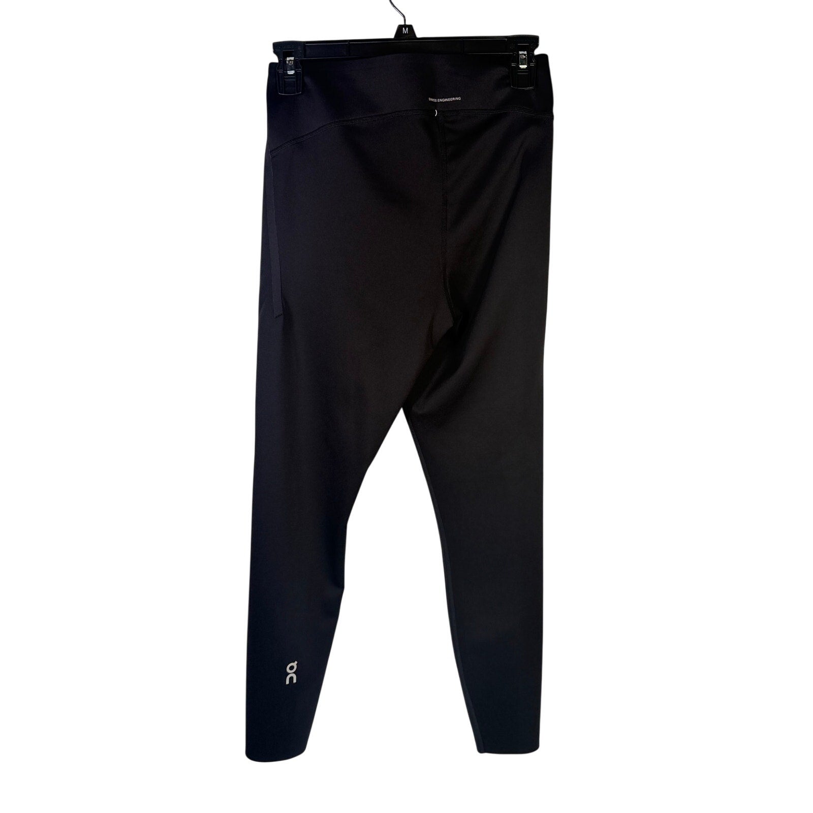 Black On Women’s Train Tights 7/8 leggings in size M, shown flat with waistband and tapered leg design.