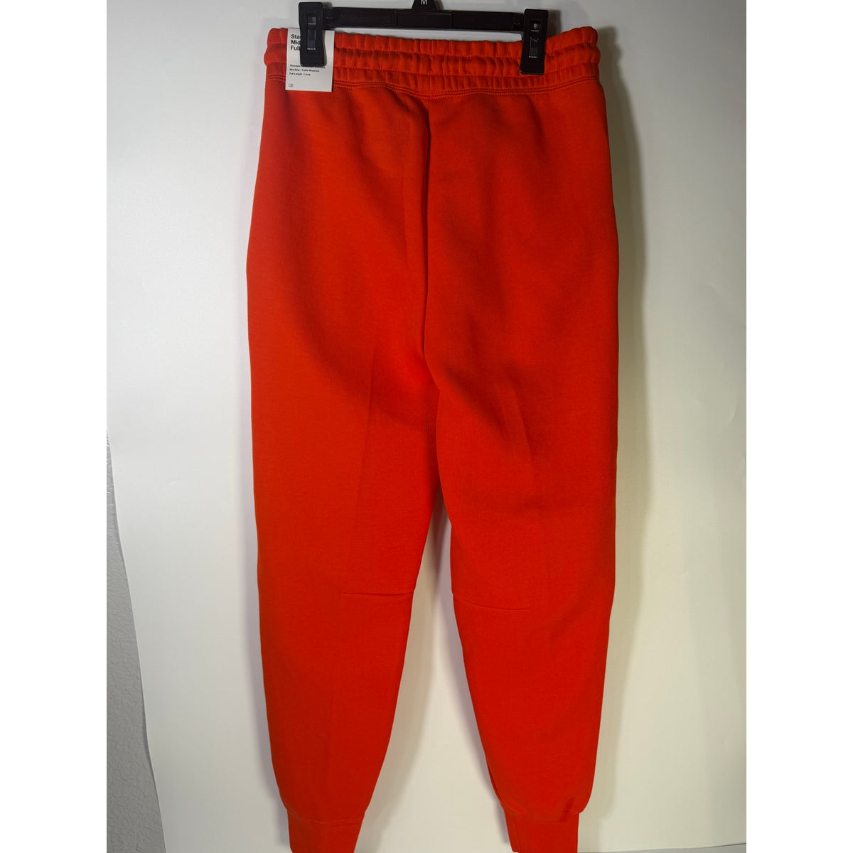 Nike Sportswear Phoenix Fleece jogger pants in bright orange, women's XS, mid-rise with comfortable fleece fabric.