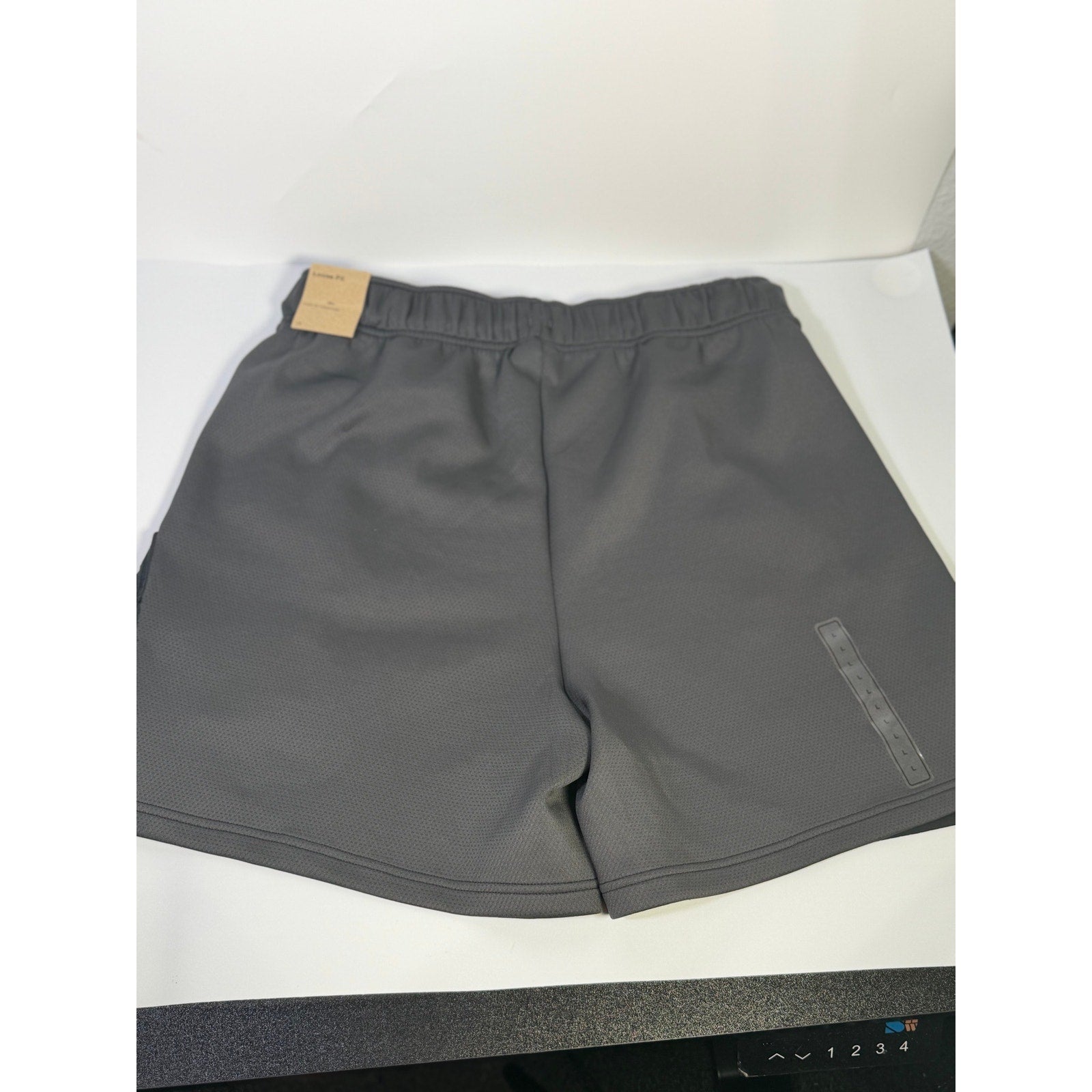 Nike ACG Death Bloom women's black cargo shorts, size M, with multiple pockets and casual fit, front view.