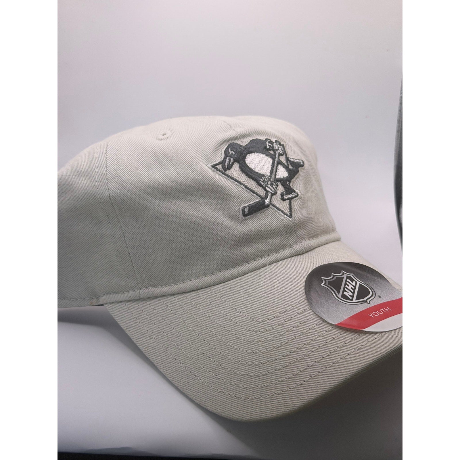 NHL Pittsburgh Penguins youth adjustable strapback hat in beige, featuring team logo and cap design, one size fits most.