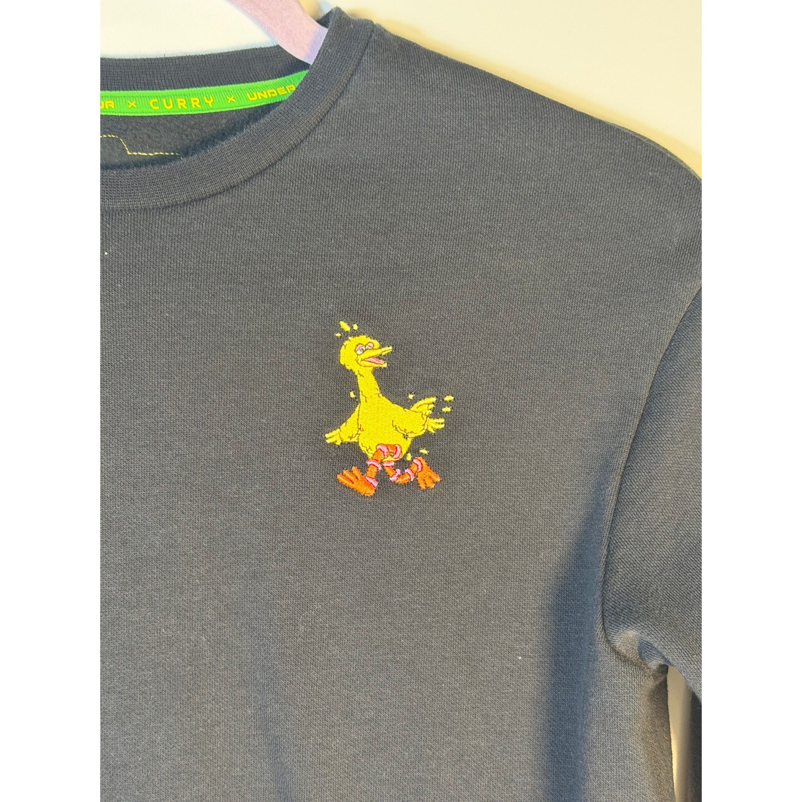 Under Armour Curry Sesame Street Big Bird youth sweatshirt in black, featuring Big Bird graphic, for boys and men.