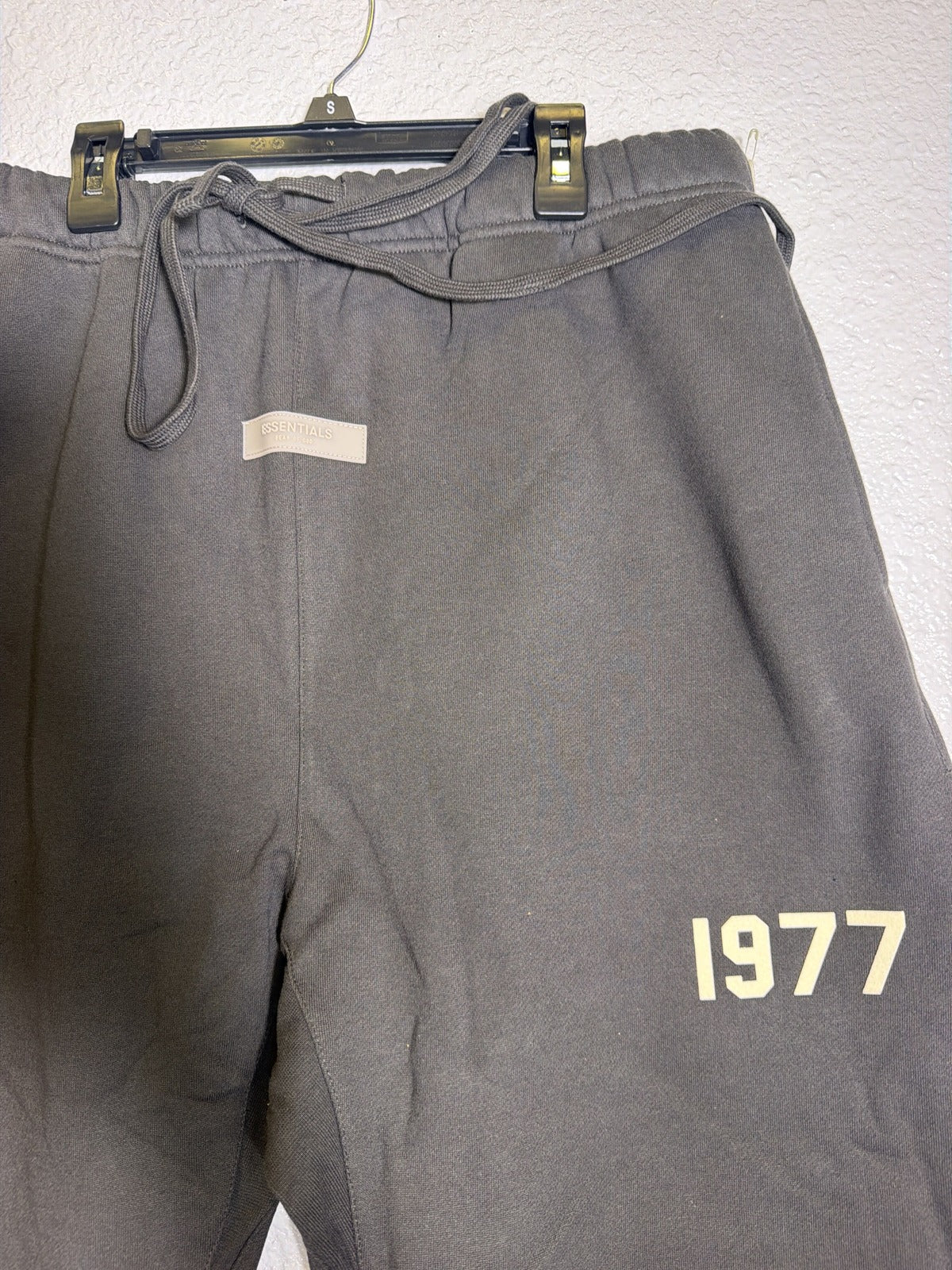 Fear of God Essentials 1977 Sweatpants in iron color, size XXL, showing relaxed fit with elastic waistband and cuffed ankles.