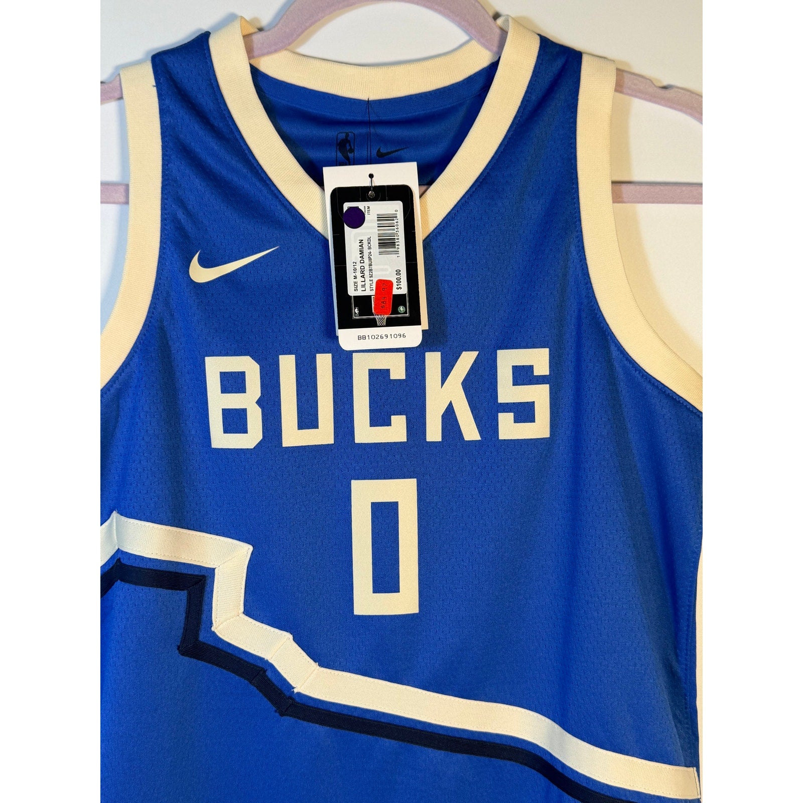 Nike Milwaukee Bucks Damian Lillard #0 City Edition youth jersey in size M, featuring team logo and vibrant team colors.
