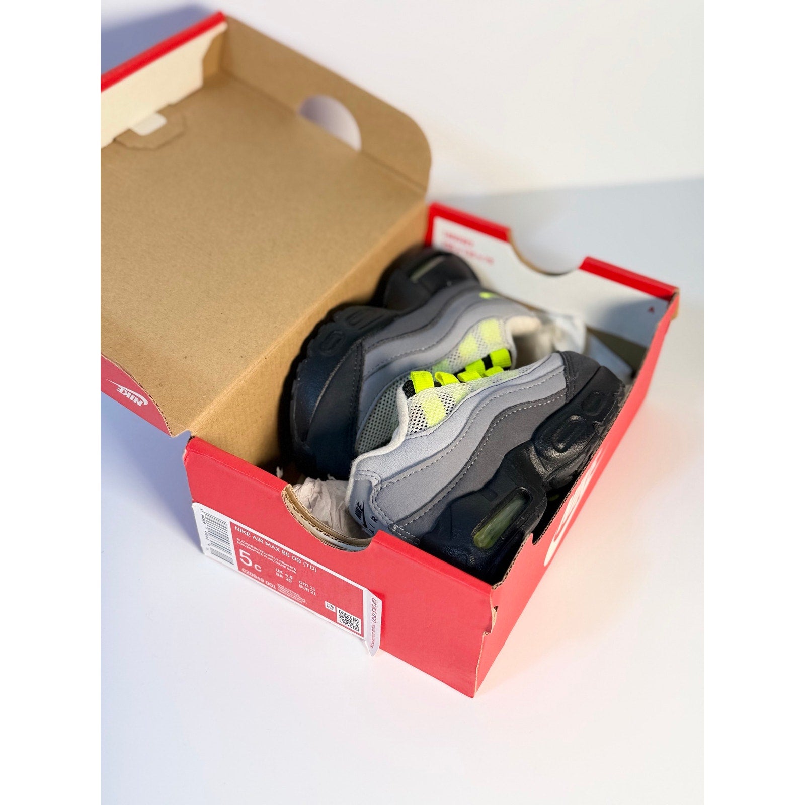 Nike Air Max 95 toddler sneakers in gray, volt, and black with running shoe design for kids.