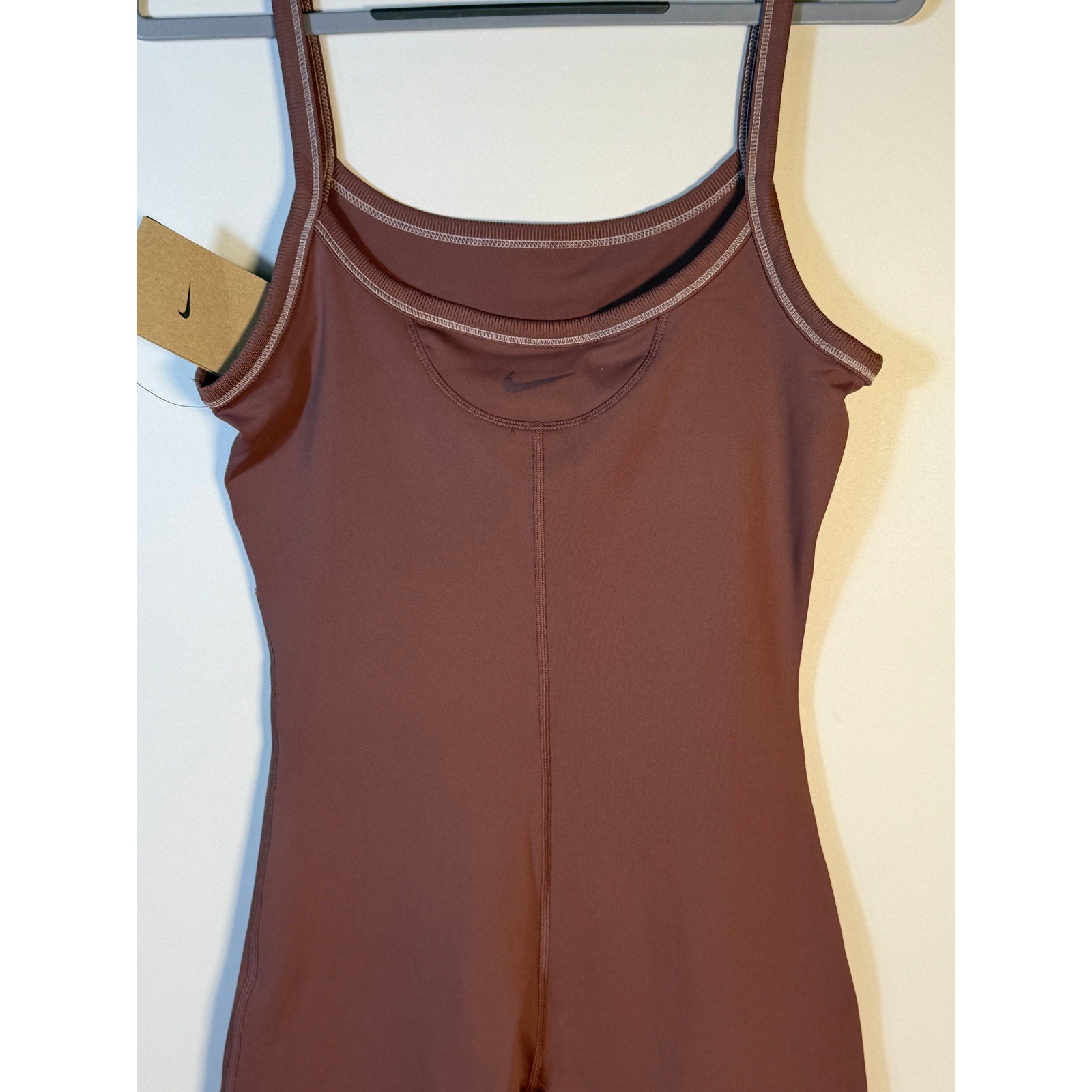 Nike women's mauve training romper, size small, one-piece bodysuit, casual athletic wear, front view with fitted design.